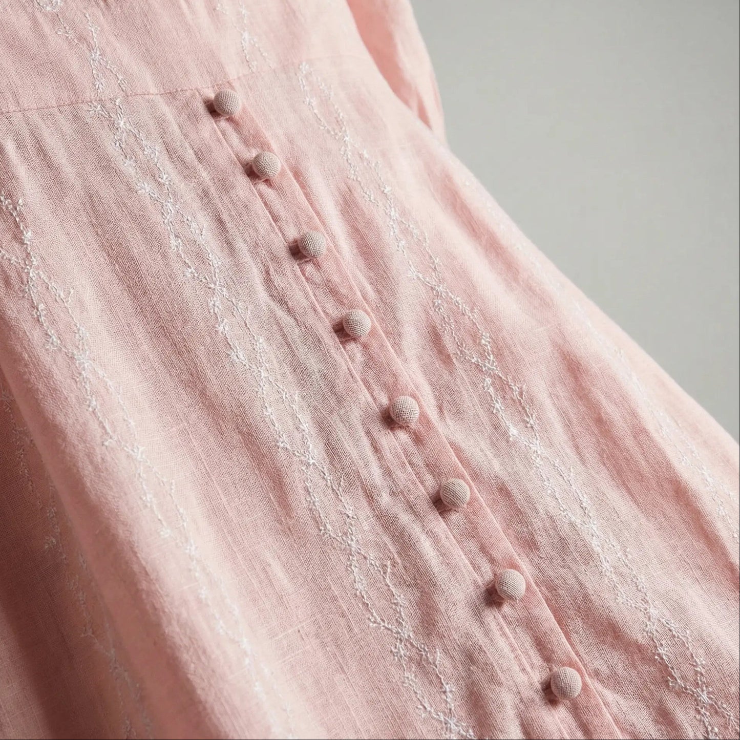 Closeup of Peach Aura blush modest maxi dress with long sleeves