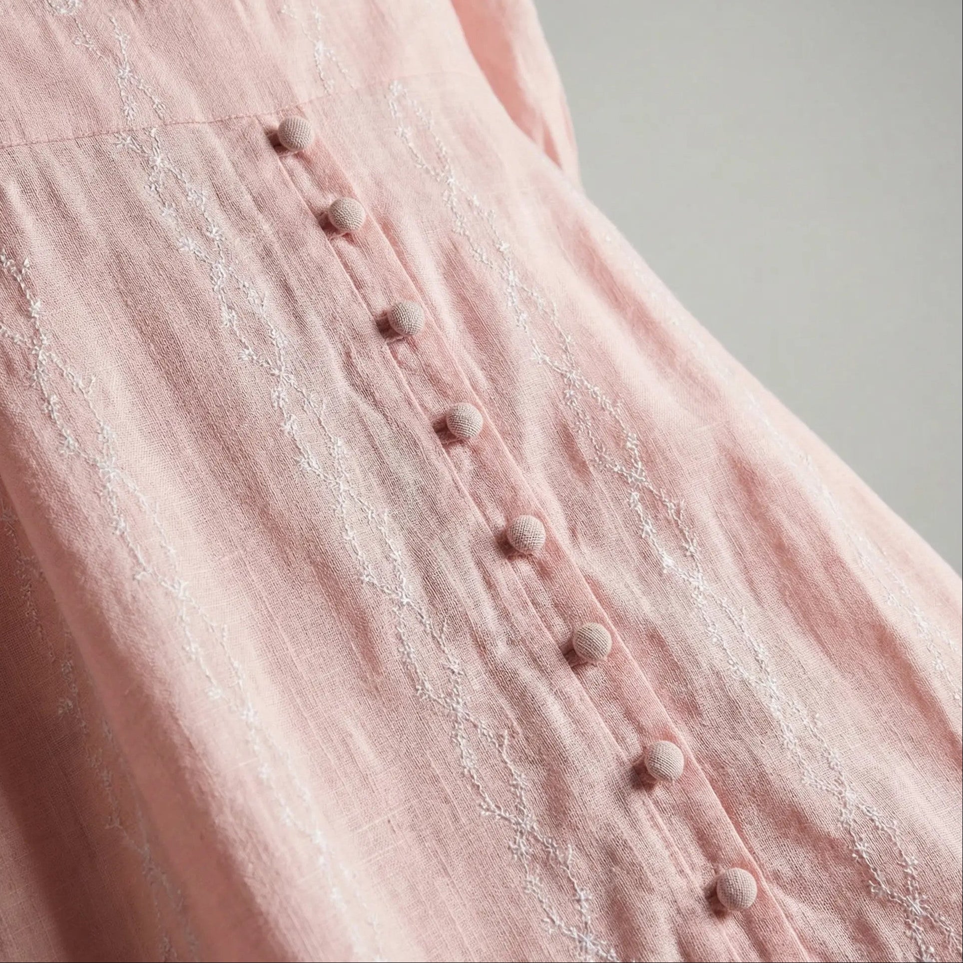 Closeup of Peach Aura blush modest maxi dress with long sleeves